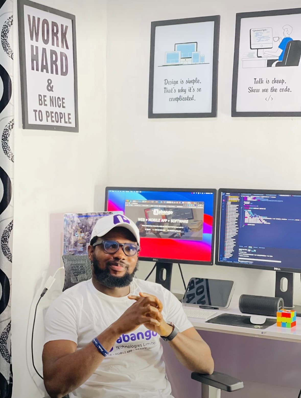 Abiodun in the Abango office, reviewing a project on his laptop